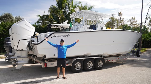 happy client just received his boat after Just Right Boat Hauling transported it